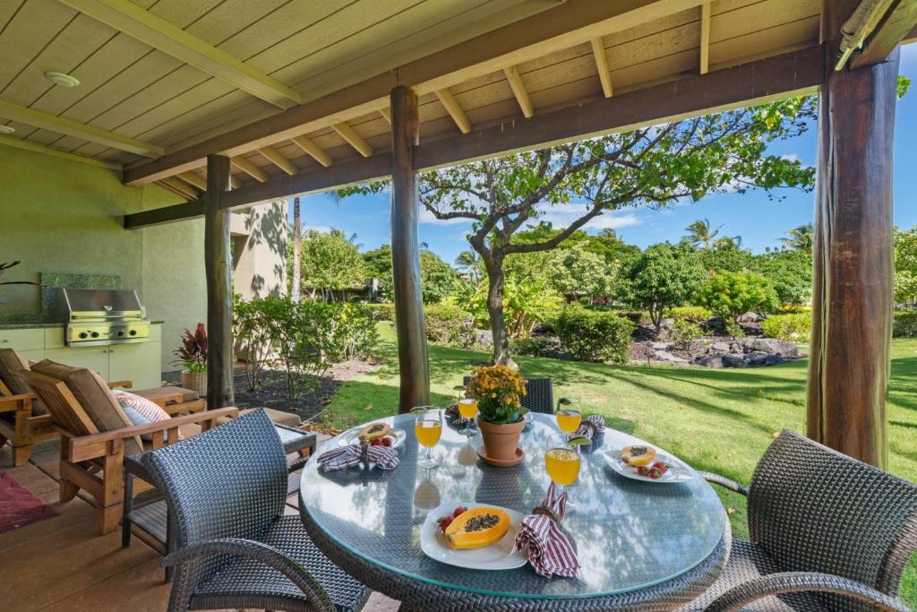 a table with food and drinks on a patio at Big Island Fairways at Mauna Lani 1705 townhouse in Waikoloa
