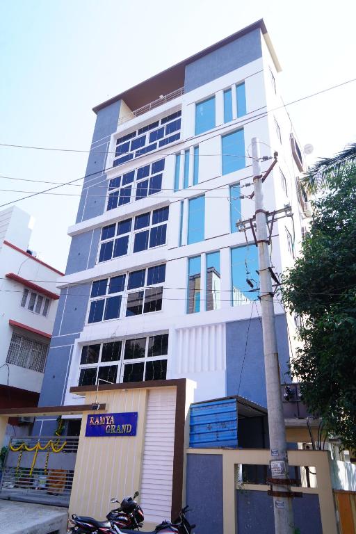 a tall building with motorcycles parked in front of it at Ramya Grand in Visakhapatnam