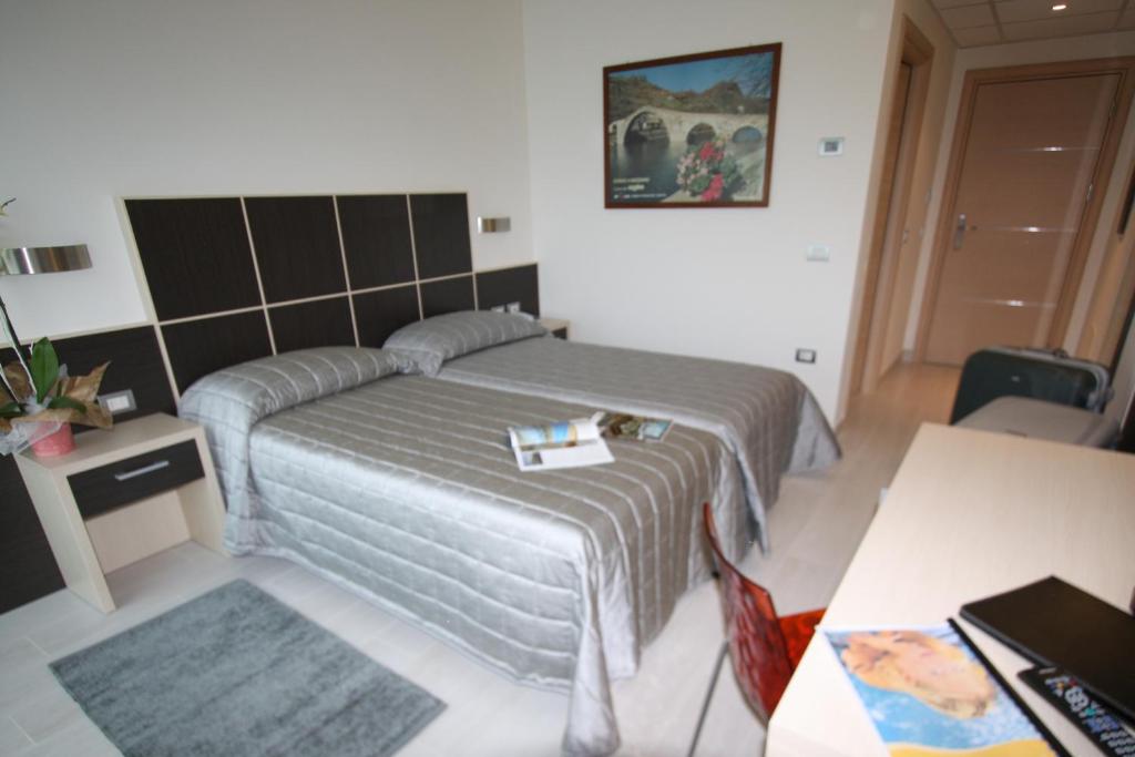 Postel nebo postele na pokoji v ubytování Hotel Garnì Corallo