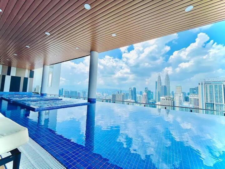 a swimming pool with a view of a city skyline at NJ Homestay @ Colony By Infinitum in Kuala Lumpur