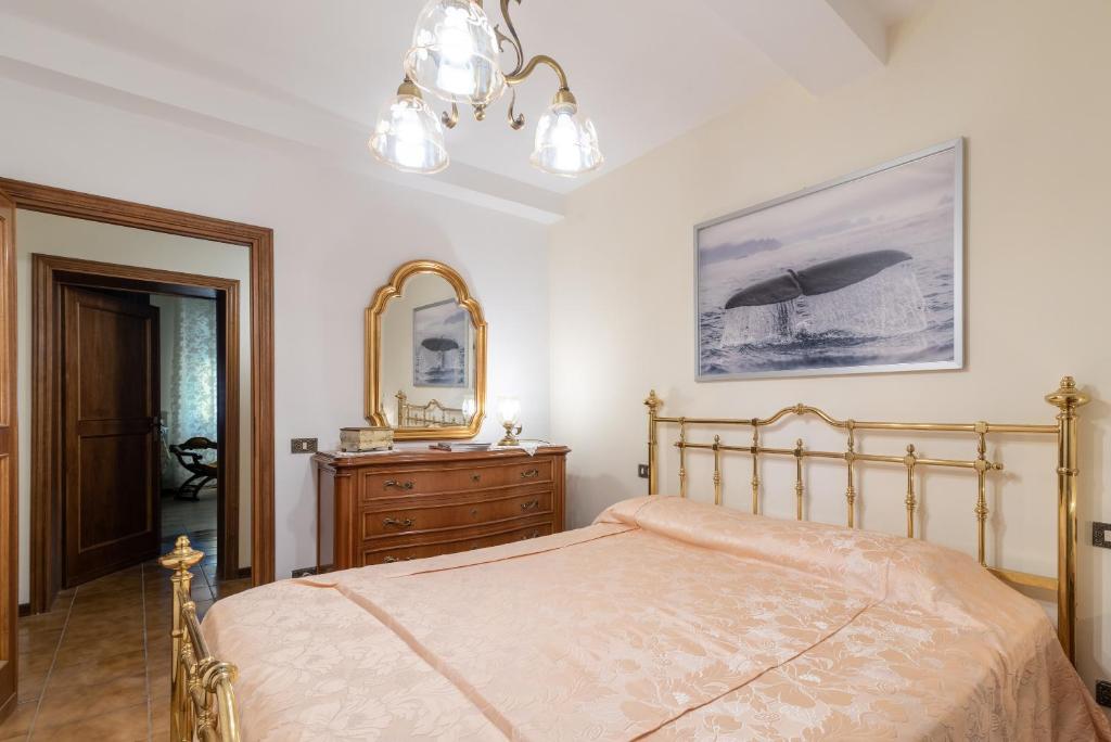 um quarto com uma cama, uma cómoda e um espelho em Le Balze nel cuore della Toscana em Castelfranco di Sopra