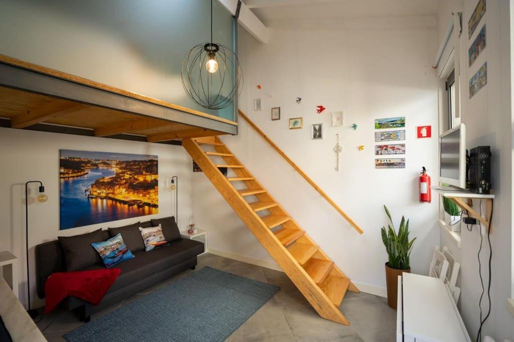 uma sala de estar com uma escada e um sofá em Ilha D'ouro House S. Vitor II em Porto