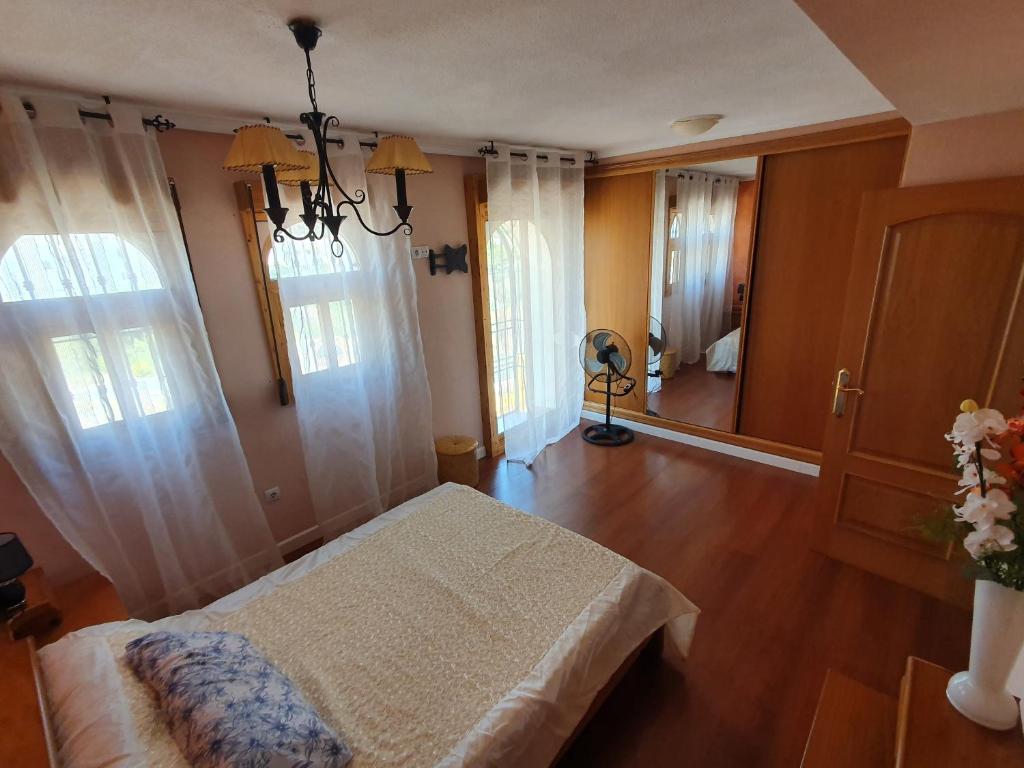 a bedroom with a bed and a room with a mirror at Apartamento Alkabir Playa in El Campello