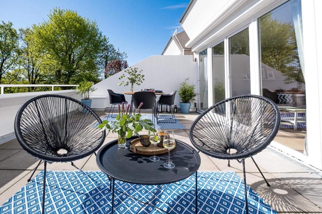 a patio with two chairs and a table on a patio at Panoramic App C03-4 Sonnendeck in Sierksdorf