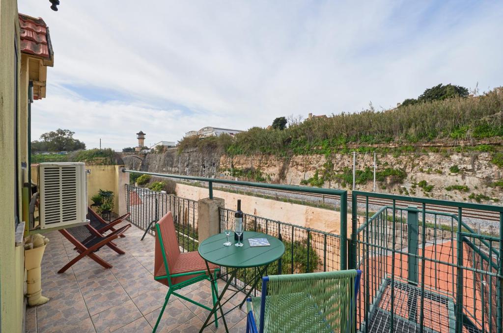 a patio with a table and chairs on a balcony at Bright Apt w Balcony, AC, Parking, By TimeCooler in Lisbon