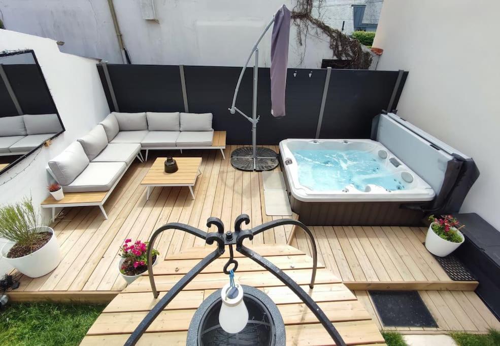 un pequeño patio con bañera de hidromasaje en una terraza en Ô'date gîte &spa en Nantes