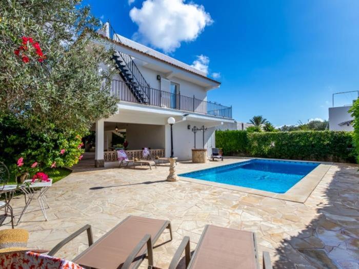 a villa with a swimming pool and a house at Can Joan in Santanyi