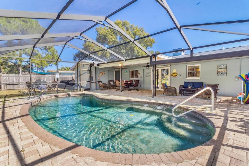 a swimming pool in a yard with a house at Perfect for Family Gatherings with a Heated Pool! - Clearwater's Clear Choice in Clearwater