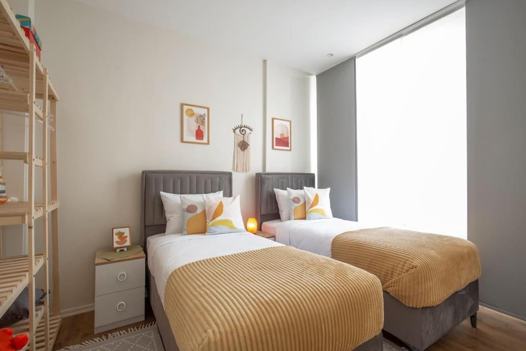 A bed or beds in a room at Modern Flat with Central Location near Nisantasi