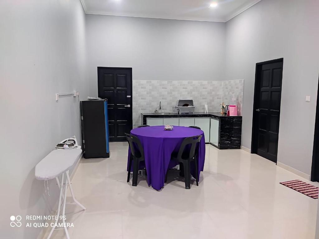 a kitchen with a purple table in a room at The Family Guesthouse in Kota Bharu