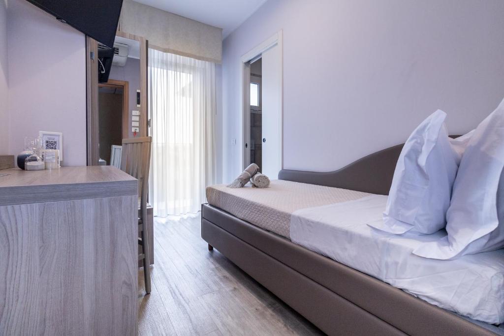 Postel nebo postele na pokoji v ubytování Hotel Alfonsina