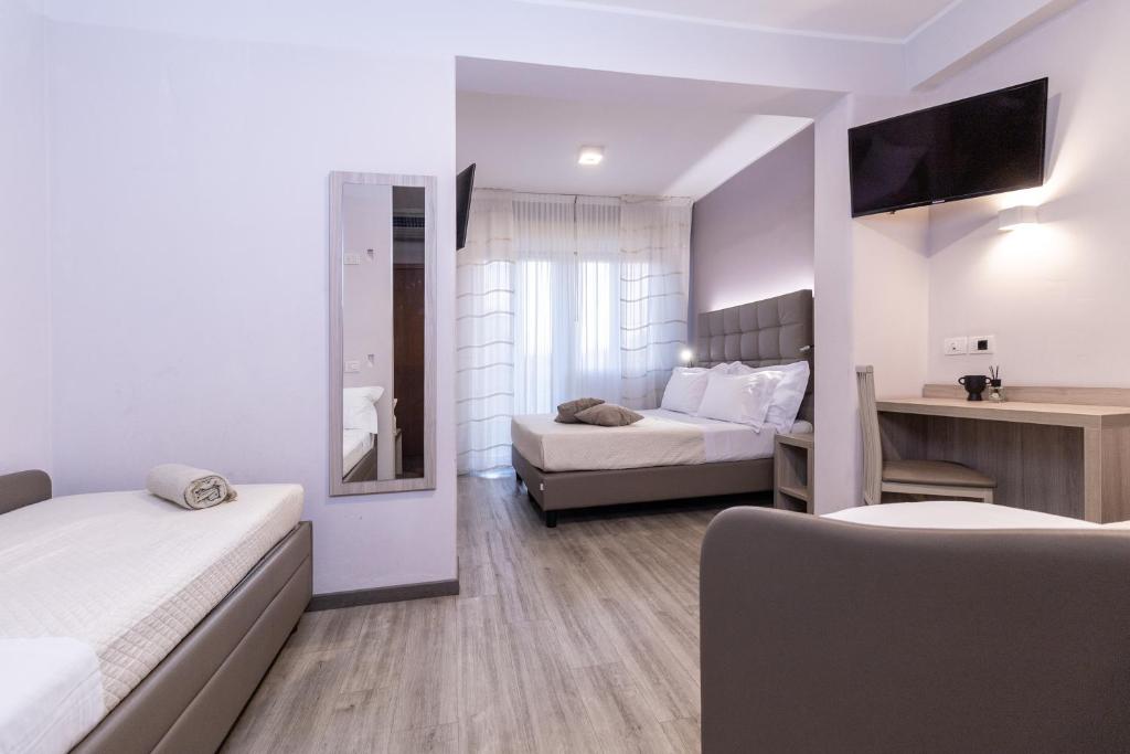 Postel nebo postele na pokoji v ubytování Hotel Alfonsina