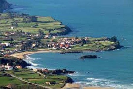 an island in the ocean with houses and houses at Hotel La Isla in Colunga