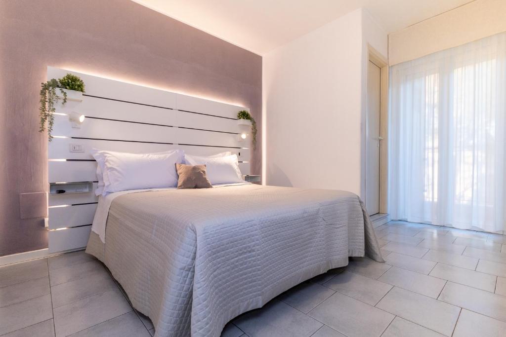 Postel nebo postele na pokoji v ubytování Hotel Alfonsina