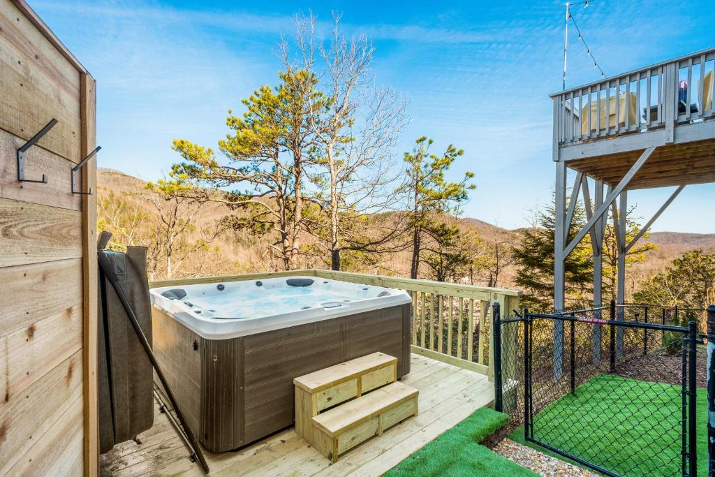 a hot tub on the deck of a house at Winston's Ridge in Fairview