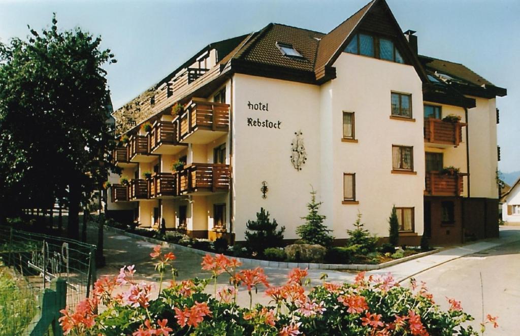 a building with a sign on the side of it at Hotel Rebstock in Ohlsbach