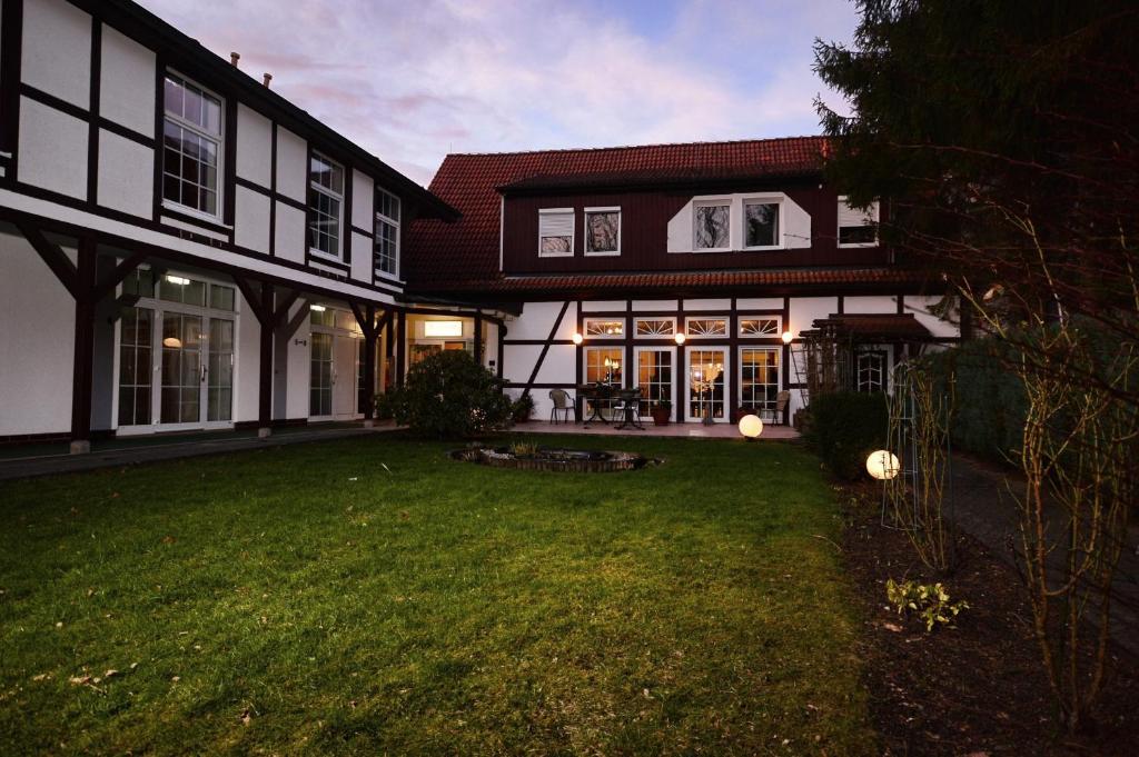 a house with a lawn in front of it at Hotel am Stadtwald in Stralsund