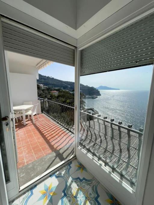 a room with a balcony with a view of the water at Villa sul mare in Massa Lubrense