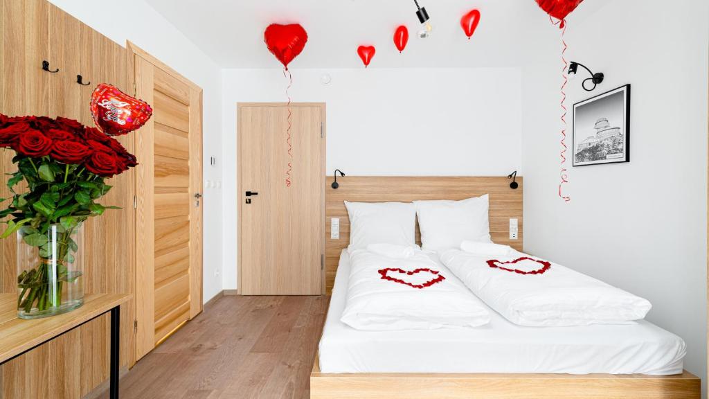 a bedroom with a bed with red hearts on it at Emilly Center in Karpacz