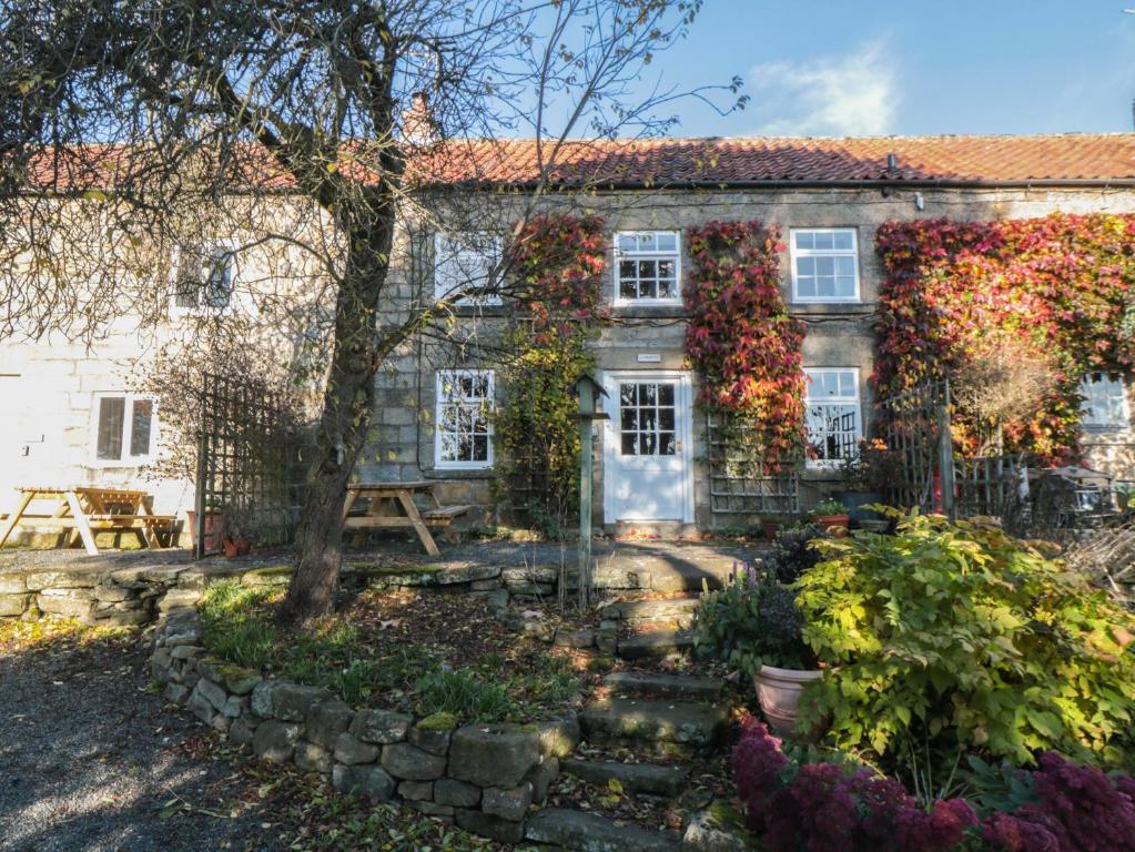 an old house with a garden in front of it at The Cottage in Pickering