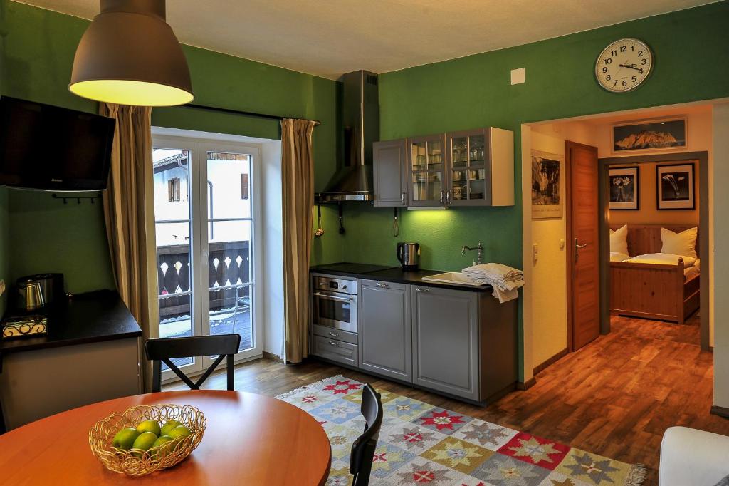 a kitchen with a table with a bowl of fruit on it at Haus Montana in Lermoos