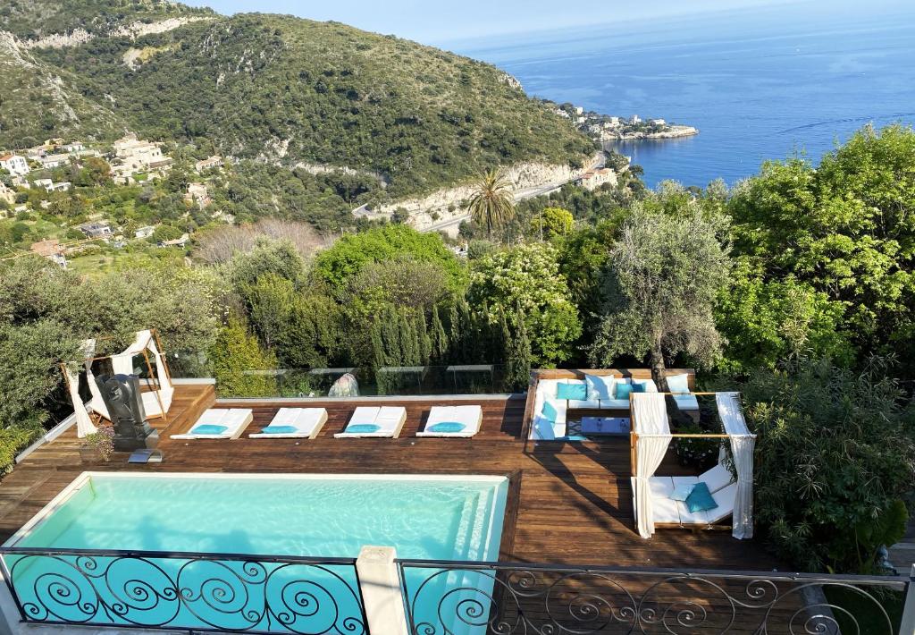 a pool on a deck with a view of the ocean at Luxurious studio suite near Monaco with sea view in Éze