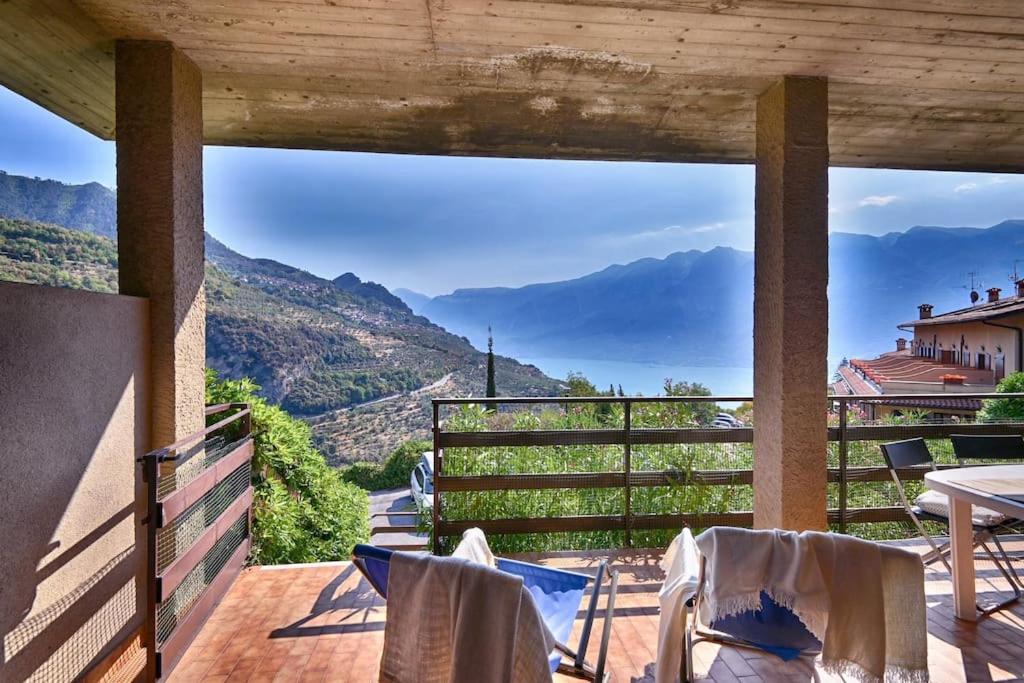 a balcony with chairs and a view of the mountains at Belvedere Beatrice - Rebomaholidays in Olzano