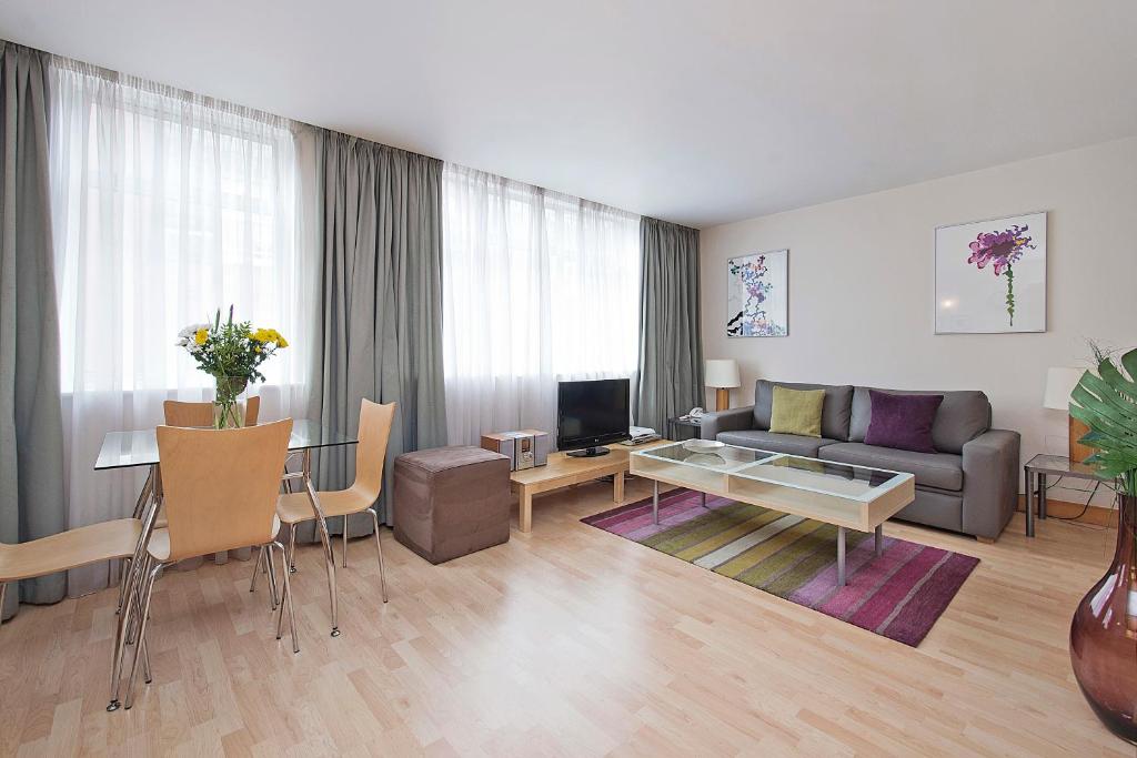 a living room with a couch and a table at St Christopher's Place Serviced Apartments by Globe Apartments in London