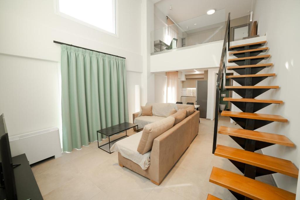 a living room with a couch and a staircase at Athens Heart Luxury Apartment in Athens