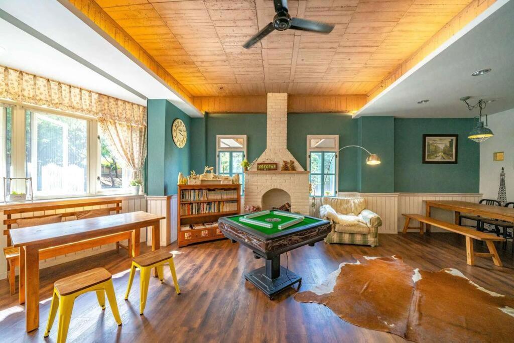 a living room with a pool table and a fireplace at Hejia B&amp;B in Hualien City