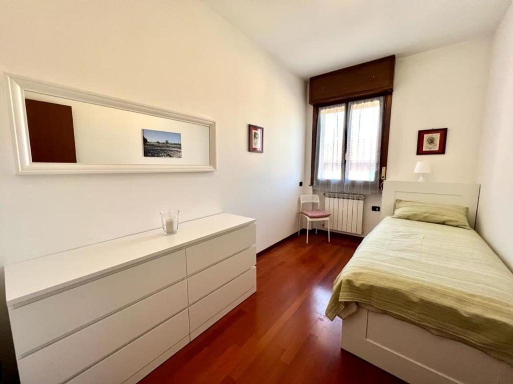 a bedroom with a bed and a dresser in it at Todeschini 27 in Brembate