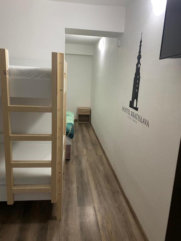 a room with bunk beds and a wall with a tower on it at Hostel Old Town in Bratislava
