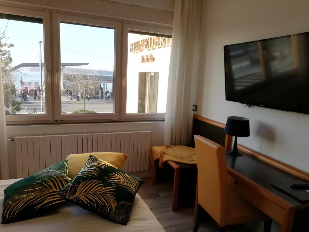 a room with a desk and a television and a table with pillows at Hotel Belvedere in Venice-Lido