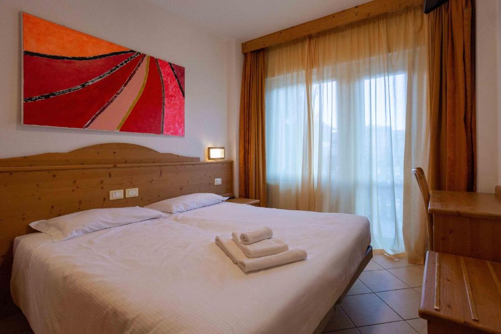 Postel nebo postele na pokoji v ubytování Hotel Andalo