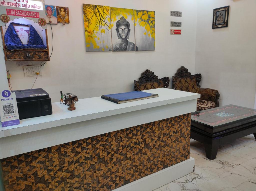 a counter in a room with two chairs and a table at hotel khubsaras palace by chhabra's in Agra