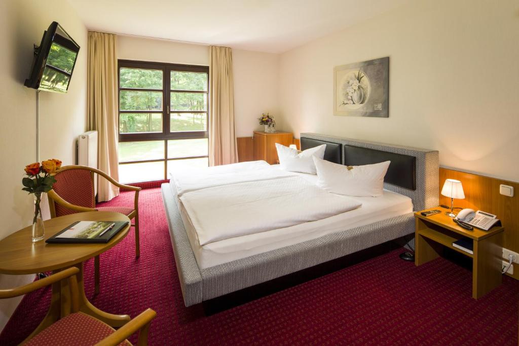 Postel nebo postele na pokoji v ubytování Kim Hotel Im Park