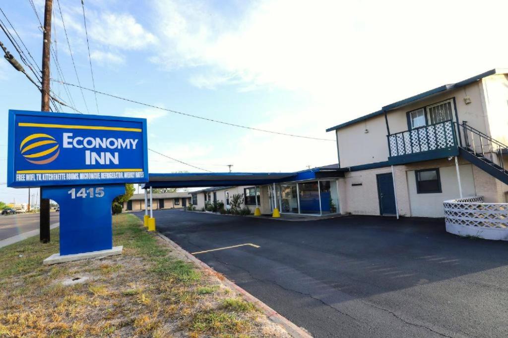 a sign for a economy inn in front of a building at Economy Inn Kingsville in Kingsville