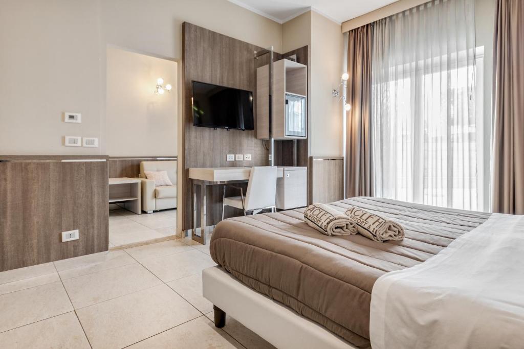 Postel nebo postele na pokoji v ubytování Eracle Hotel
