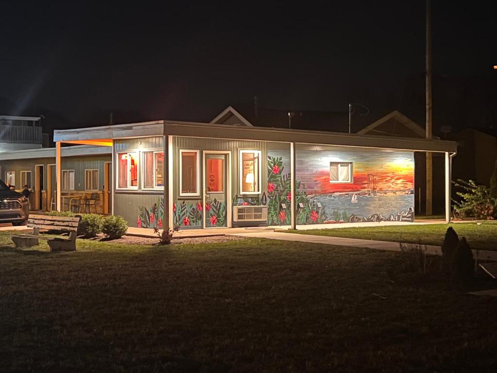 a house with a mural on the side of it at night at The Cedar Motel in Sandusky