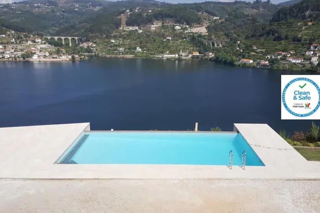 a swimming pool with a view of a lake at Casa das Oliveiras, o Douro no seu esplendor! in Cinfães