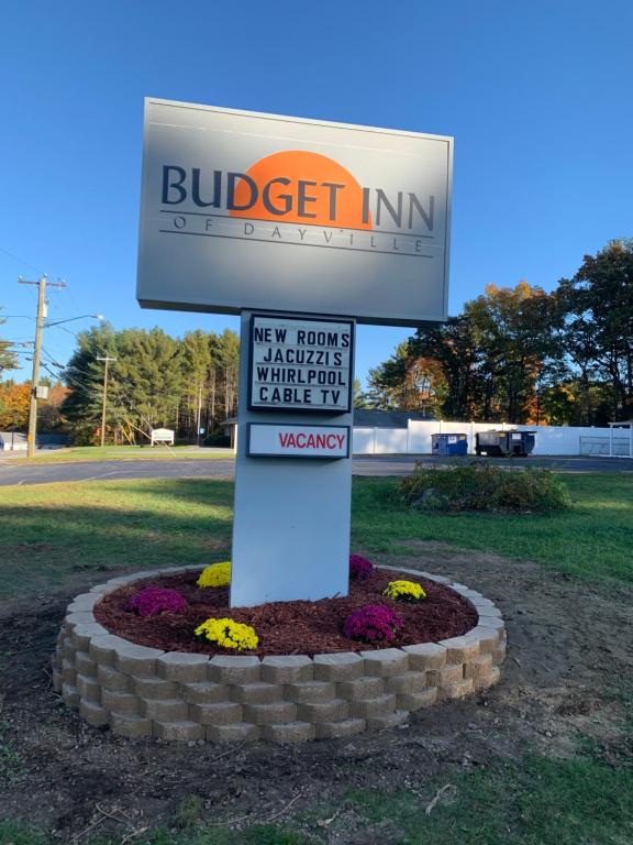 a sign for a buiger inc sign in a flower bed at Budget Inn in Dayville