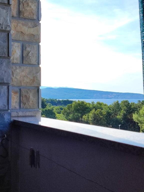 a balcony with a view of the mountains at Apartments Pika in Krk
