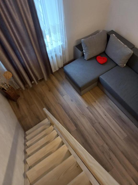 a living room with a couch and a staircase at Сьоме Небо in Lviv