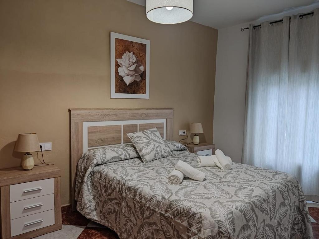 a bedroom with a bed with two pillows on it at Casa Fregenal Centro R&S in Fregenal de la Sierra