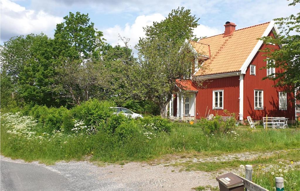 una casa rossa con una macchina parcheggiata di fronte di Nice Home In Ormaryd With Kitchen a Ormaryd