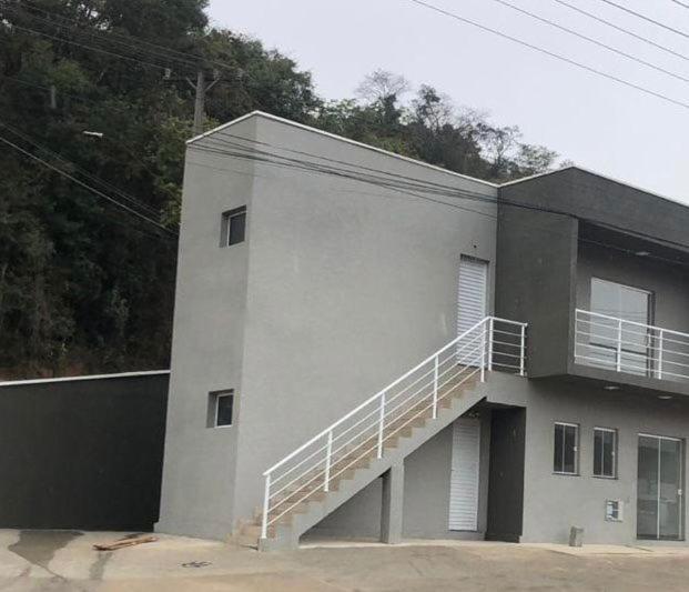 a building with a staircase on the side of it at VILLAGE Host Hotel in Pedra Bela