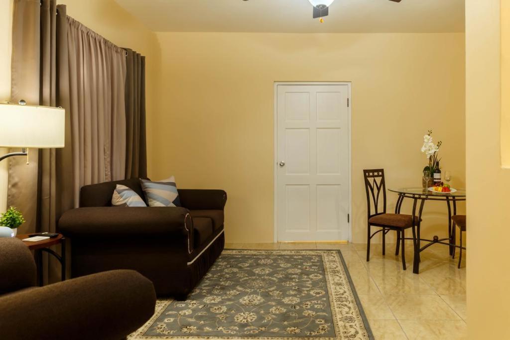 a living room with a couch and a table at Cozi Cottage, A Tranquil Beauty in The Rock