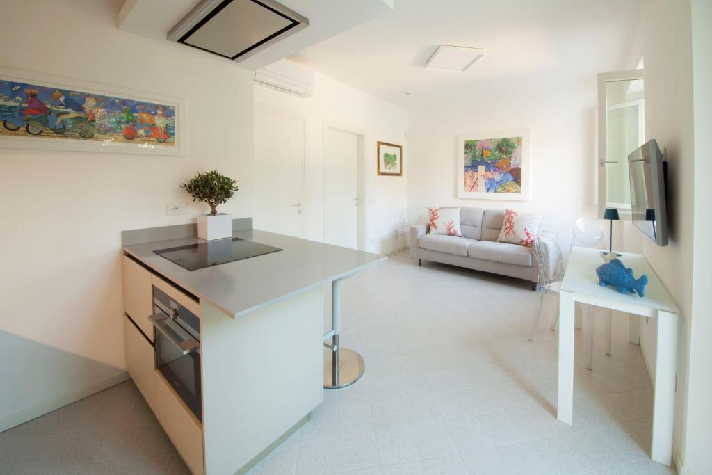 a kitchen and living room with a sink and a couch at Via Zug in Castiglioncello