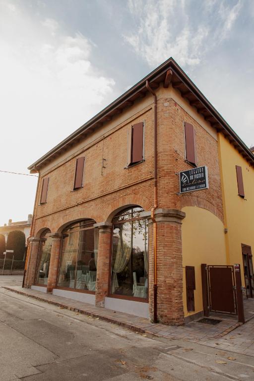 a brick building with a sign on the side of it at Locanda del vecchio mulino in Fiorano Modenese