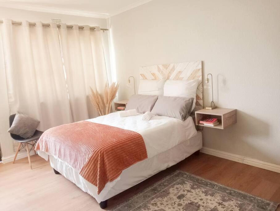 Un dormitorio con una cama grande y una ventana en Charming Studio in Stellenbosch - The Valley Stay, en Stellenbosch